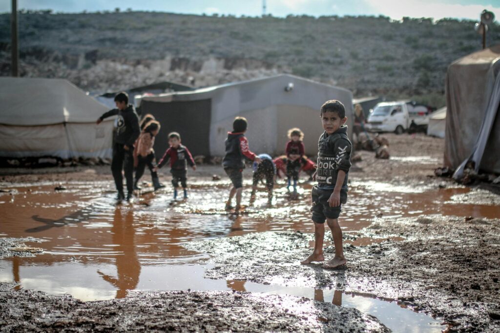 kids splashing water in puddle